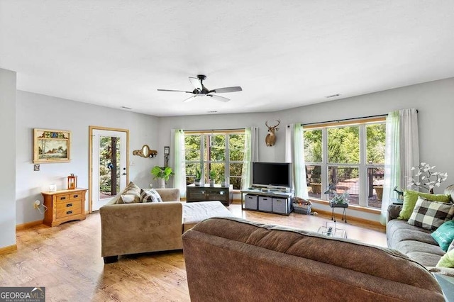 living room with light wood-type flooring and ceiling fan