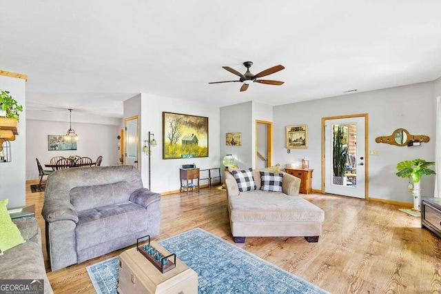 living room with light wood-type flooring and ceiling fan