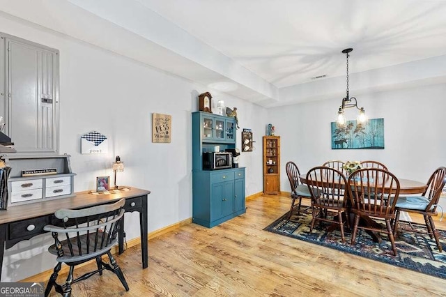 dining room with an inviting chandelier and light wood-type flooring