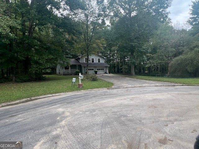 view of front of house with a garage and a front lawn