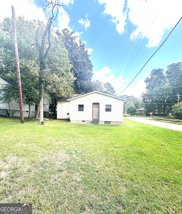 rear view of property featuring a yard