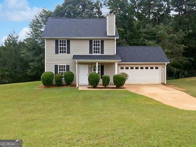 view of front of home with a garage and a front lawn