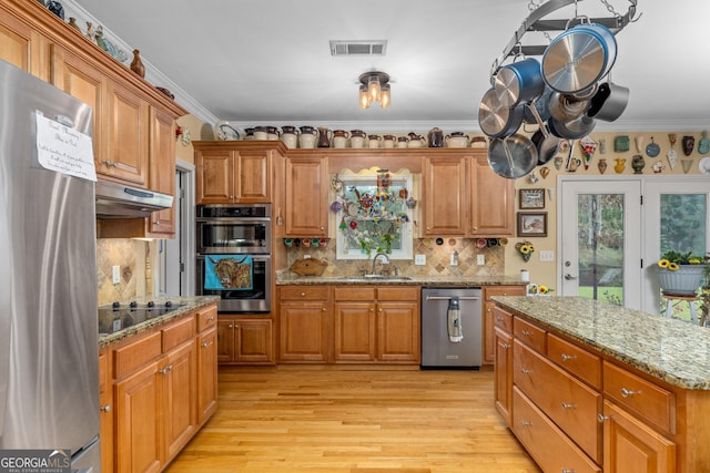 kitchen with sink, crown molding, tasteful backsplash, stainless steel appliances, and light stone countertops