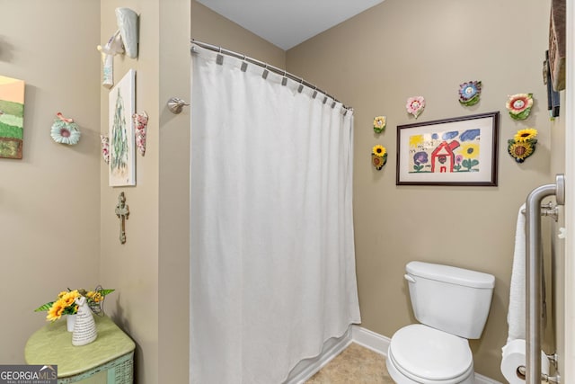 bathroom featuring tile patterned flooring and toilet