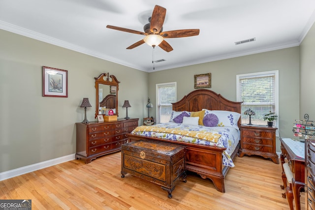 bedroom featuring multiple windows, light hardwood / wood-style flooring, ornamental molding, and ceiling fan