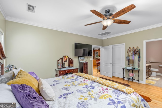 bedroom featuring crown molding, ensuite bath, light hardwood / wood-style flooring, and ceiling fan