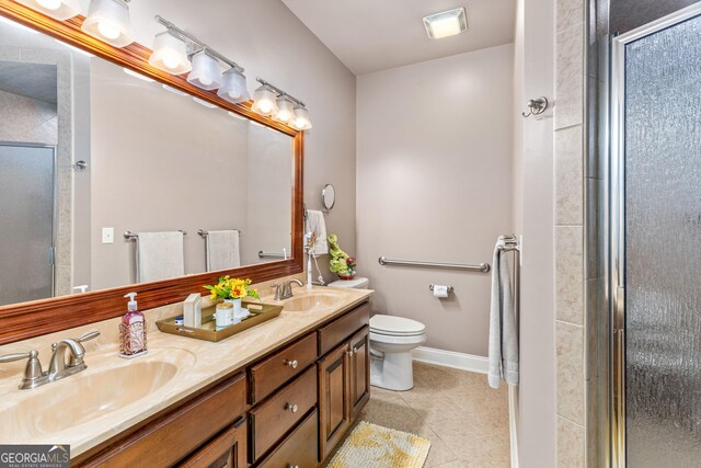 bathroom featuring vanity, tile patterned floors, and a shower with door