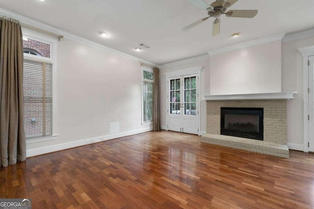 unfurnished living room with crown molding, a fireplace, ceiling fan, and hardwood / wood-style flooring