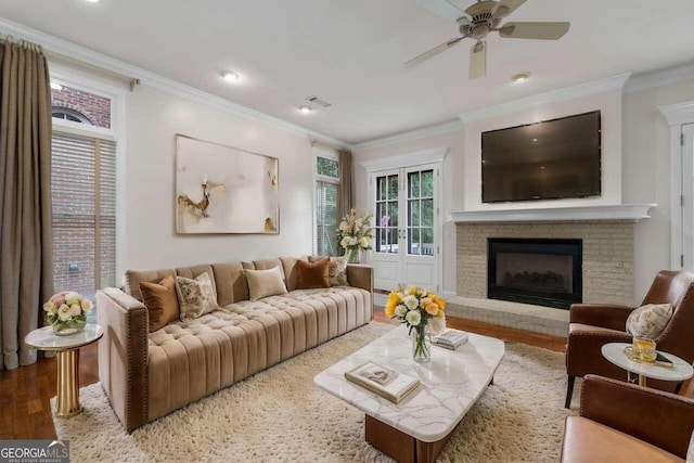 living room with ceiling fan, hardwood / wood-style flooring, and crown molding