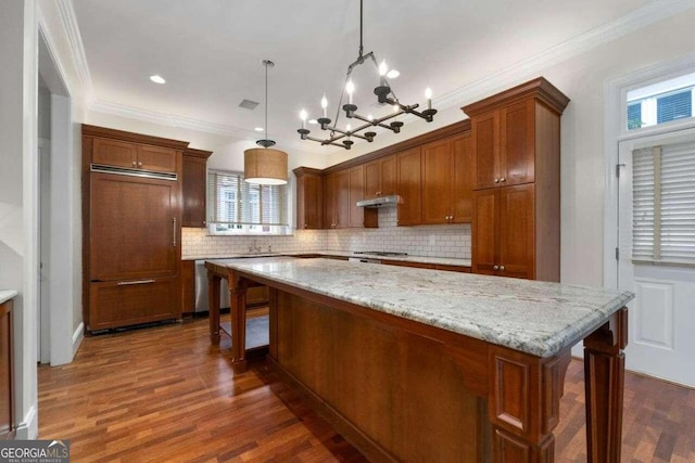 kitchen with a notable chandelier, dark wood-type flooring, plenty of natural light, and decorative light fixtures