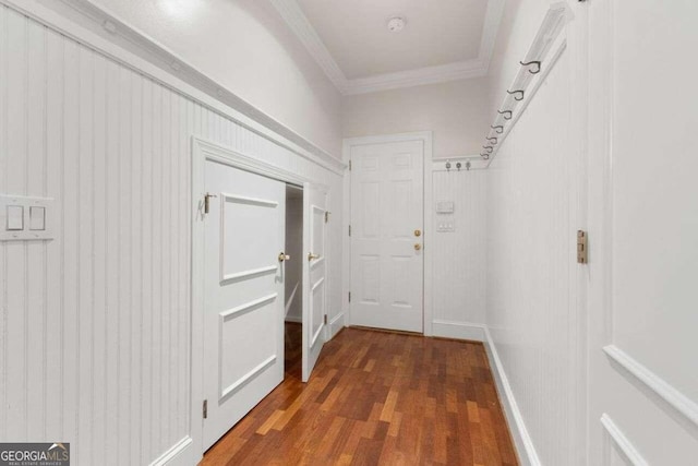 hallway featuring dark hardwood / wood-style floors and ornamental molding