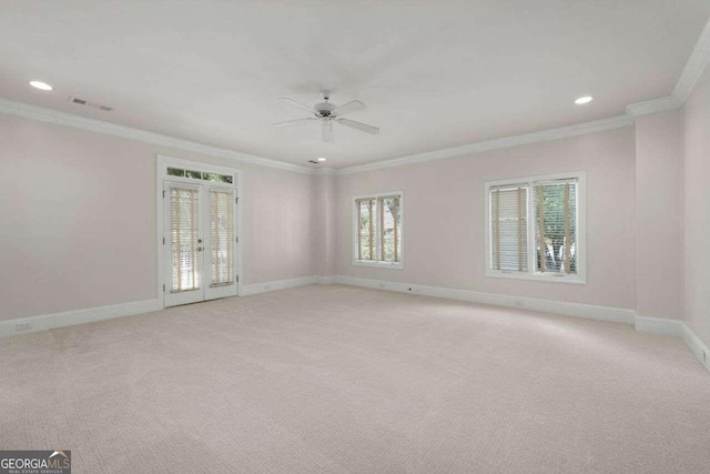 empty room with light carpet, ceiling fan, and crown molding