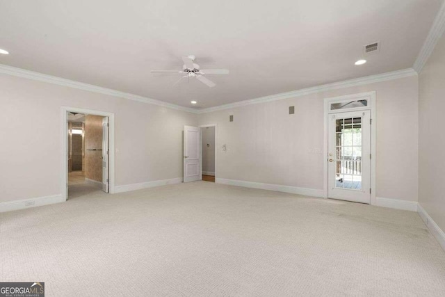 carpeted empty room featuring ceiling fan and crown molding