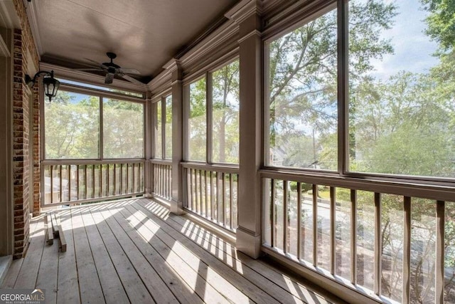 unfurnished sunroom featuring ceiling fan