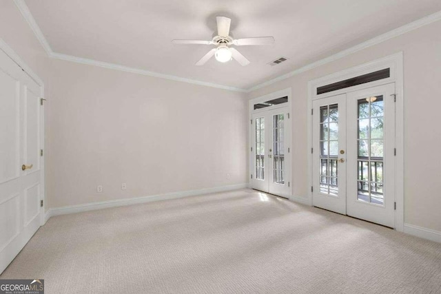 spare room with french doors, light colored carpet, ornamental molding, and ceiling fan