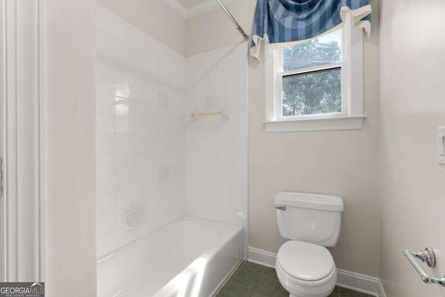 bathroom with crown molding, tiled shower / bath combo, tile patterned floors, and toilet