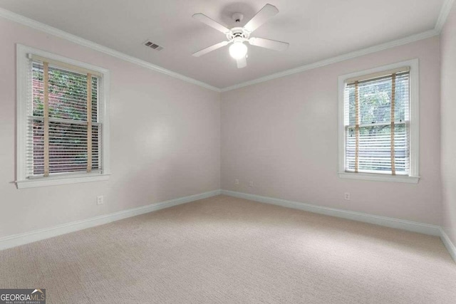 empty room featuring carpet, crown molding, and ceiling fan