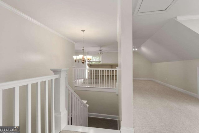 stairway featuring ornamental molding, carpet, vaulted ceiling, and ceiling fan with notable chandelier