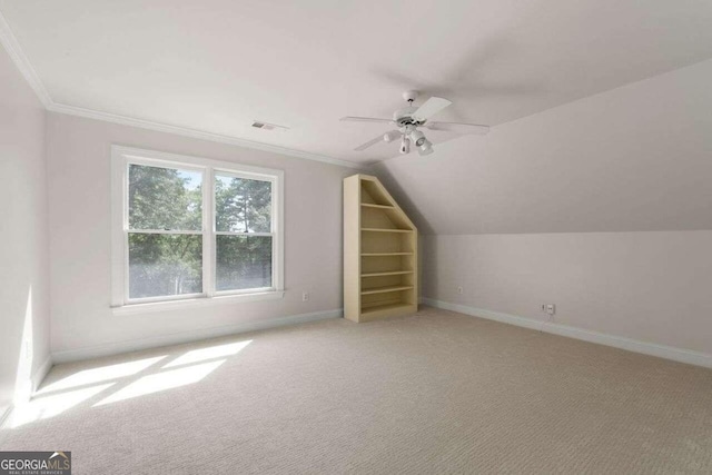 additional living space with light carpet, lofted ceiling, and ceiling fan