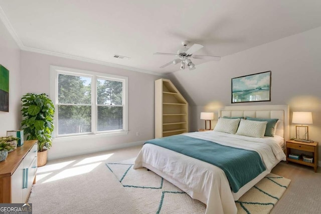 bedroom featuring ceiling fan, light carpet, vaulted ceiling, and crown molding