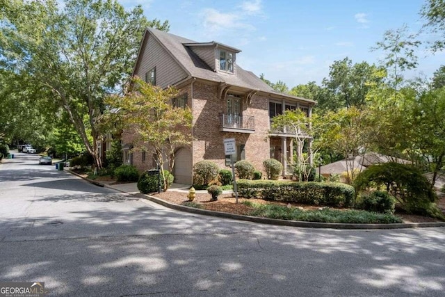 exterior space featuring a balcony and a garage