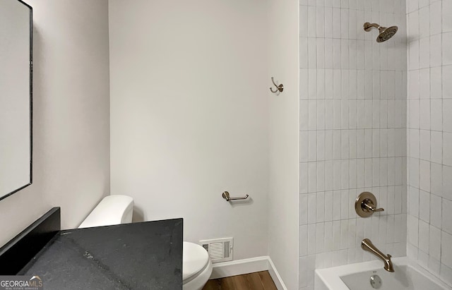 full bath featuring visible vents, baseboards, toilet, wood finished floors, and shower / bathing tub combination