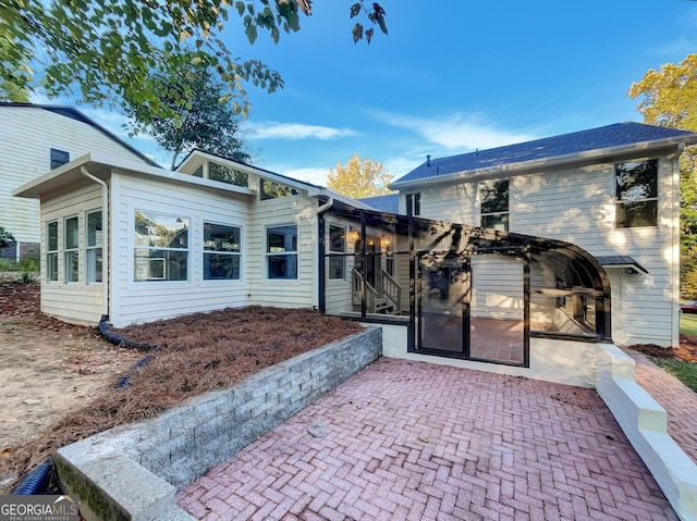 rear view of property with a sunroom