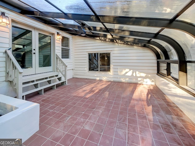 view of patio / terrace with french doors and a lanai