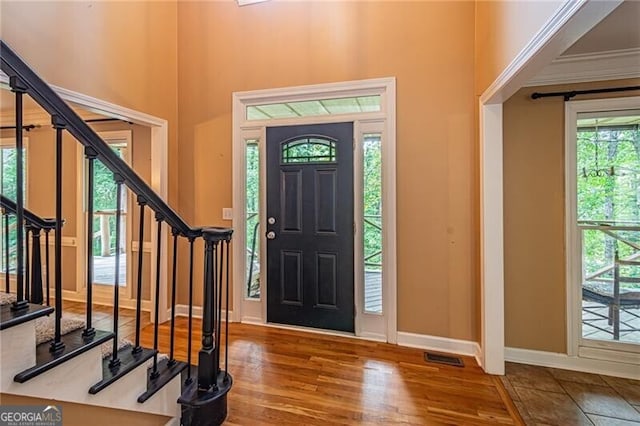 entryway featuring crown molding and hardwood / wood-style floors