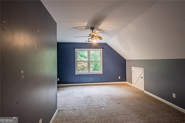 additional living space with carpet flooring, vaulted ceiling, and ceiling fan