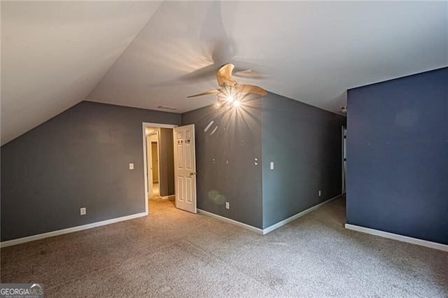 unfurnished bedroom with vaulted ceiling, ceiling fan, and carpet floors