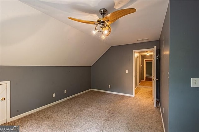 additional living space with ceiling fan, light carpet, and vaulted ceiling