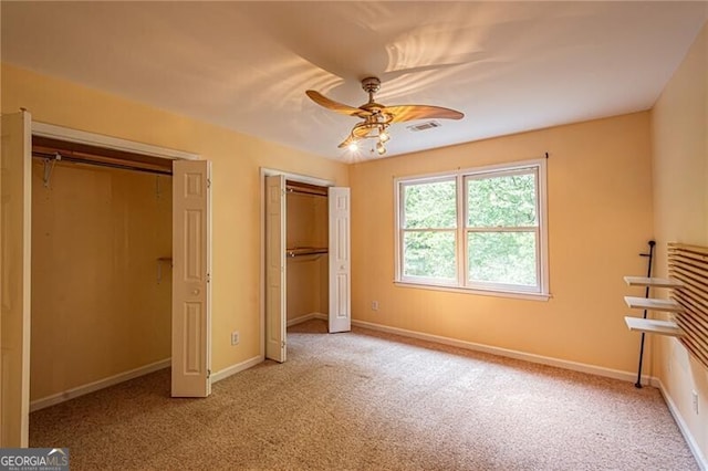 unfurnished bedroom featuring ceiling fan and carpet floors