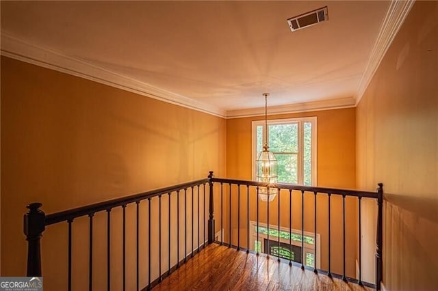 interior space with hardwood / wood-style flooring and ornamental molding