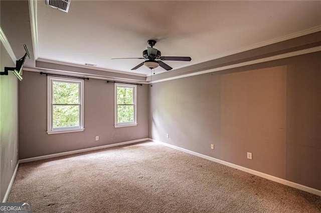 empty room featuring carpet, ceiling fan, and crown molding