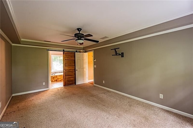 unfurnished room featuring ceiling fan, carpet floors, and a barn door