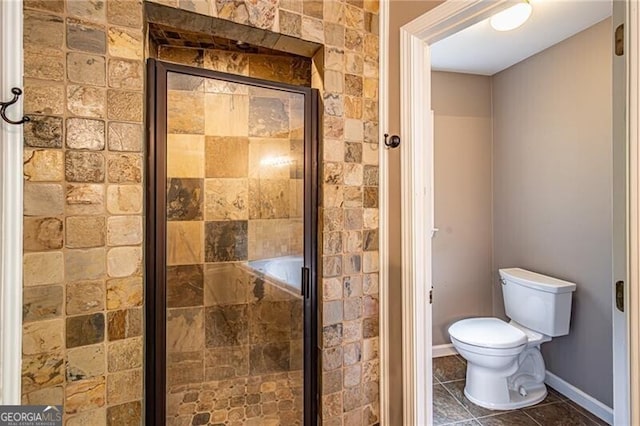 bathroom with toilet and an enclosed shower