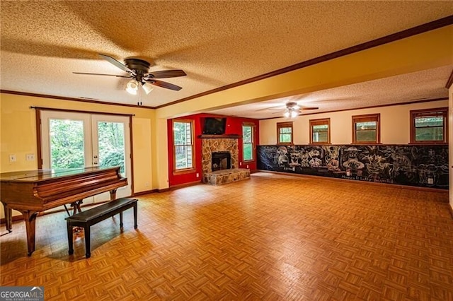 misc room with a textured ceiling, ceiling fan, and a stone fireplace