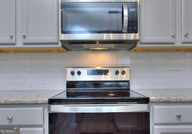 102 Greenview Ct Unit 1603, Homer, GA 30547 - detailed view of appliances with stainless steel finishes, decorative backsplash, and light stone countertops