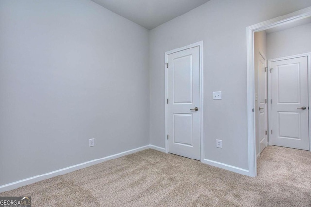 unfurnished bedroom with carpet and baseboards