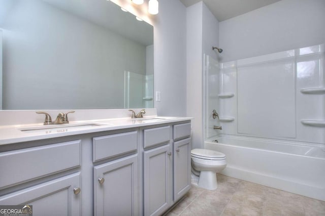 bathroom with toilet, shower / washtub combination, double vanity, and a sink