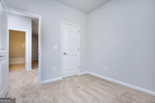 unfurnished bedroom featuring carpet and baseboards
