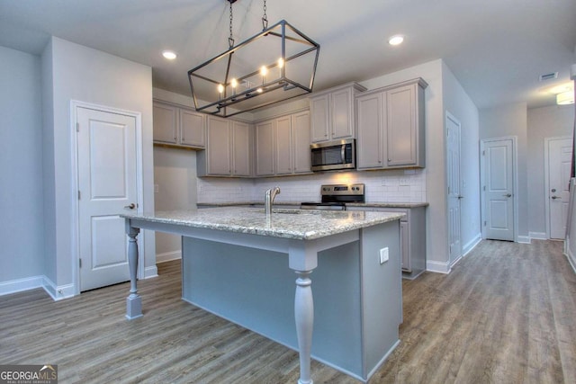 102 Greenview Ct Unit 1603, Homer, GA 30547 - kitchen with stainless steel appliances, gray cabinetry, light wood finished floors, backsplash, and an island with sink