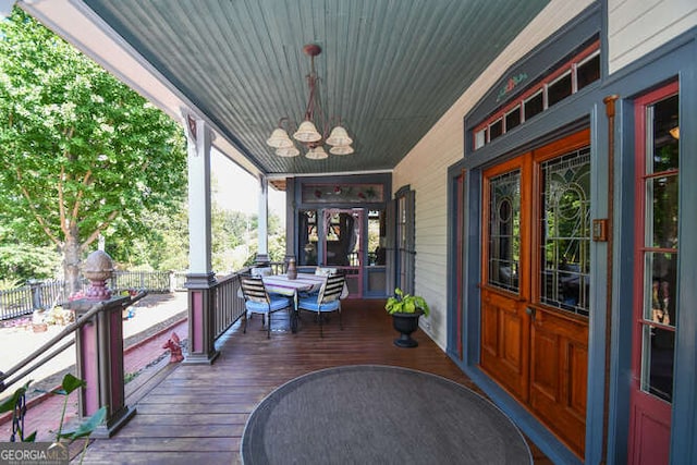 deck featuring a porch, ceiling fan, and french doors