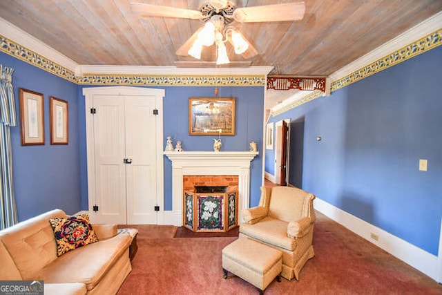 carpeted living room with ceiling fan, a fireplace, crown molding, and wooden ceiling