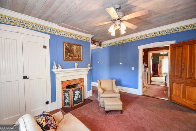 sitting room featuring ceiling fan, wood ceiling, a fireplace, and crown molding