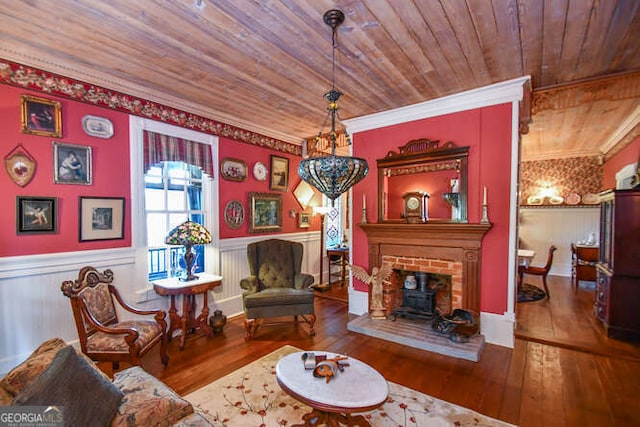 living room with wooden ceiling, wood-type flooring, crown molding, and a brick fireplace