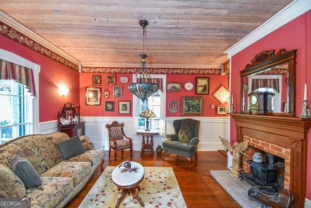 living room featuring wood ceiling, a brick fireplace, hardwood / wood-style floors, and crown molding