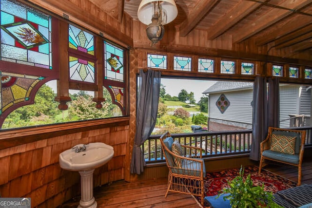 sunroom featuring wood ceiling and beamed ceiling