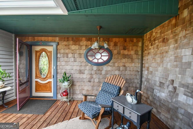 view of exterior entry with a wooden deck